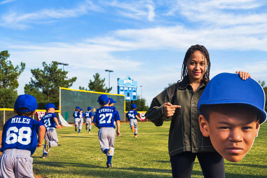 A family cheering at a baseball game with an oversized face cutout